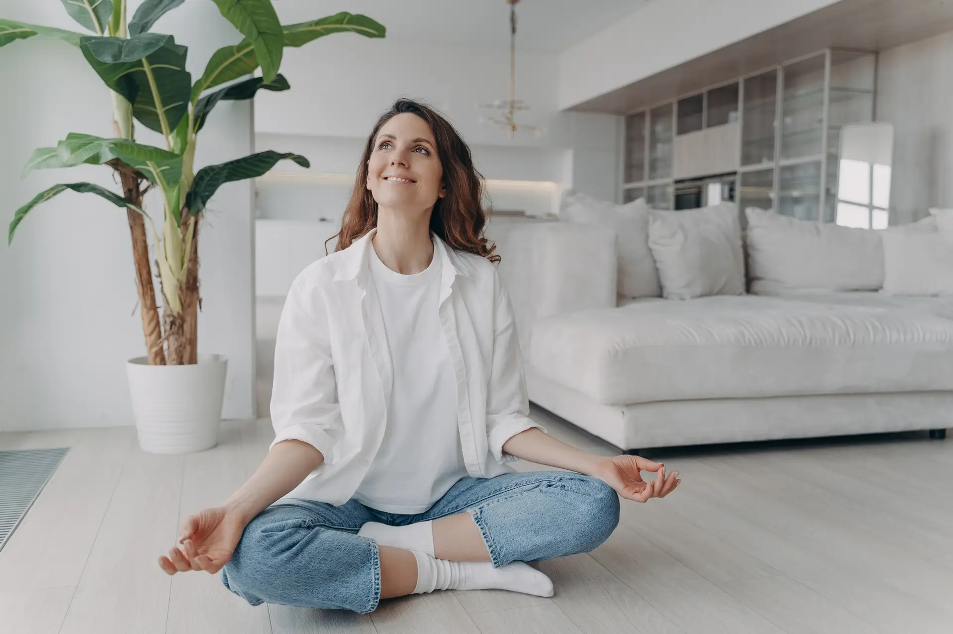Peace of mind and mental health concept. Young european woman practicing yoga on floor and smiling.